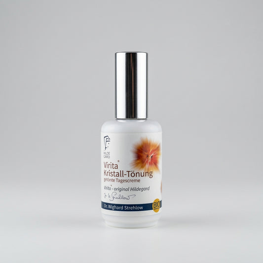 A small white bottle skin cream, featuring a label with German text and a small orange flower graphic, set against a plain light gray background.