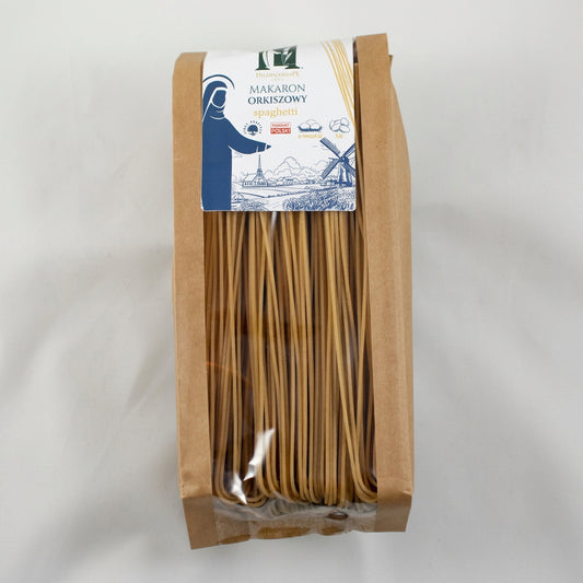 Packaged brown spaghetti with a label on a gray background